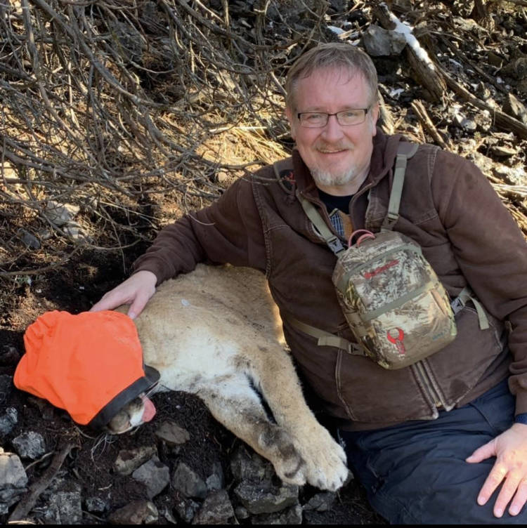 man with tagged cougar